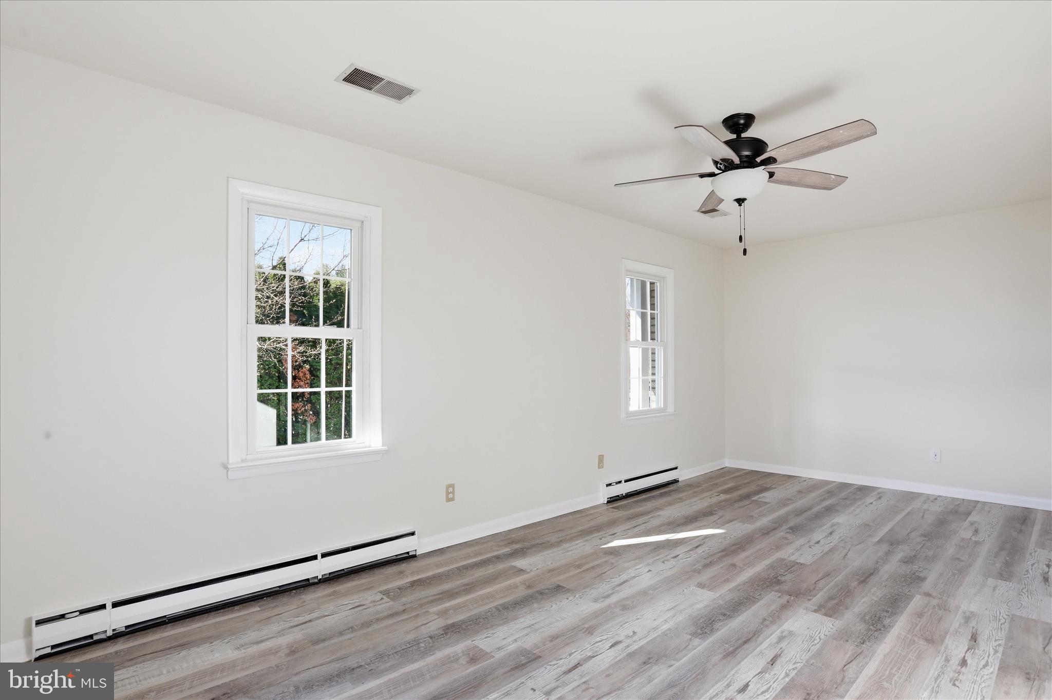 19022 Longmeadow Road Hagerstown, MD 21742 - Photo 16 of 30 a view of empty room with wooden floor and fan