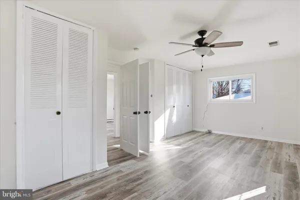 a view of a big room with wooden floor and windows in a room