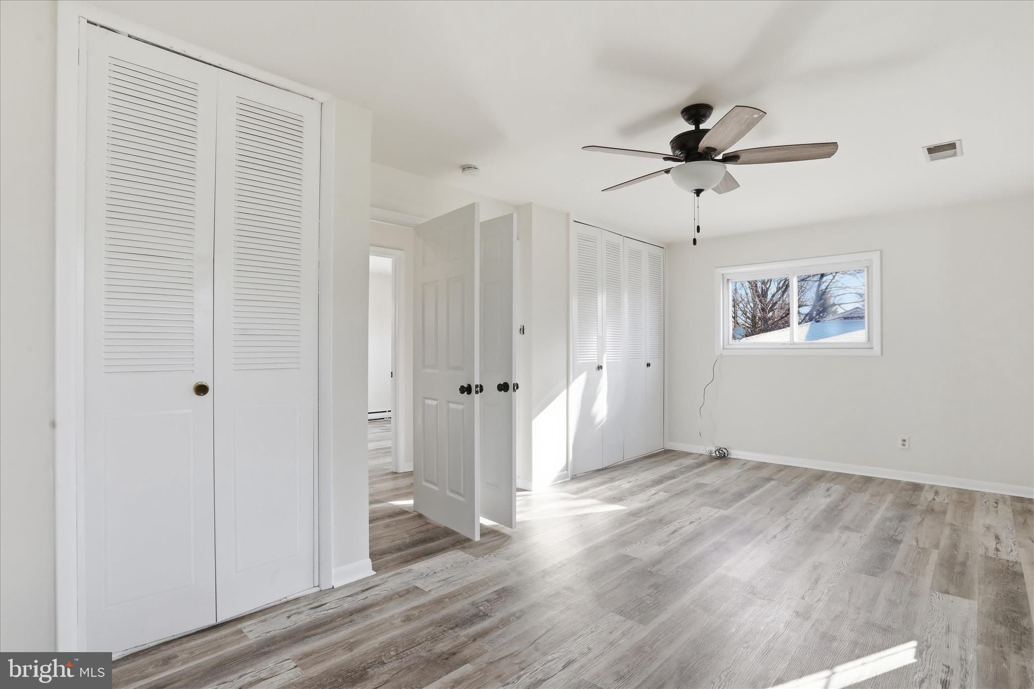 19022 Longmeadow Road Hagerstown, MD 21742 - Photo 17 of 30 a view of a big room with wooden floor and windows in a room