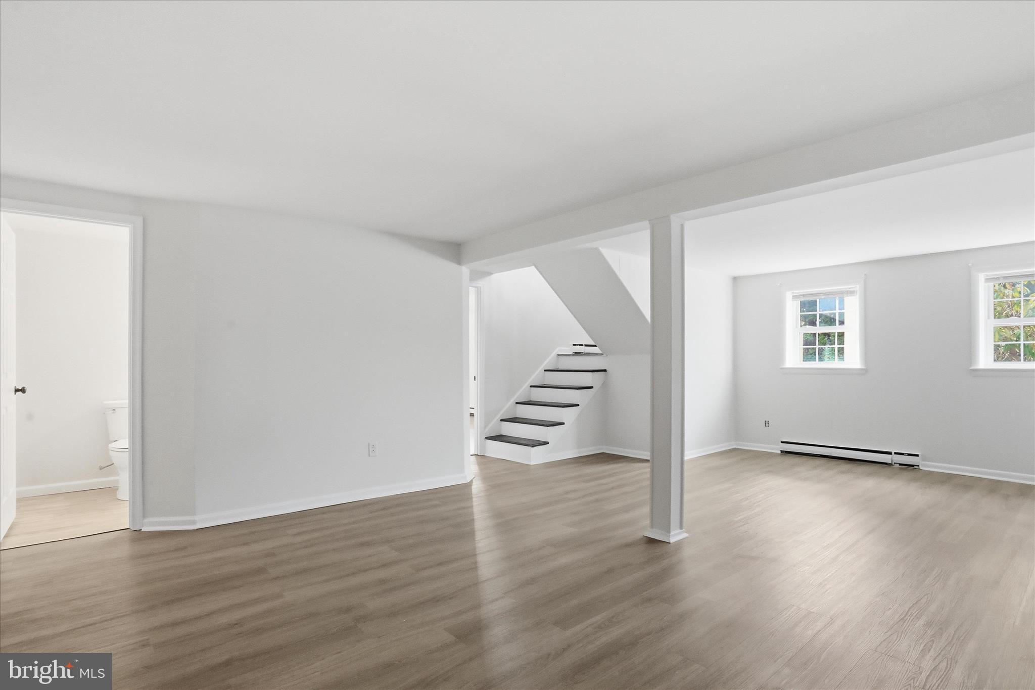 19022 Longmeadow Road Hagerstown, MD 21742 - Photo 19 of 30 an empty room with wooden floor and stairs