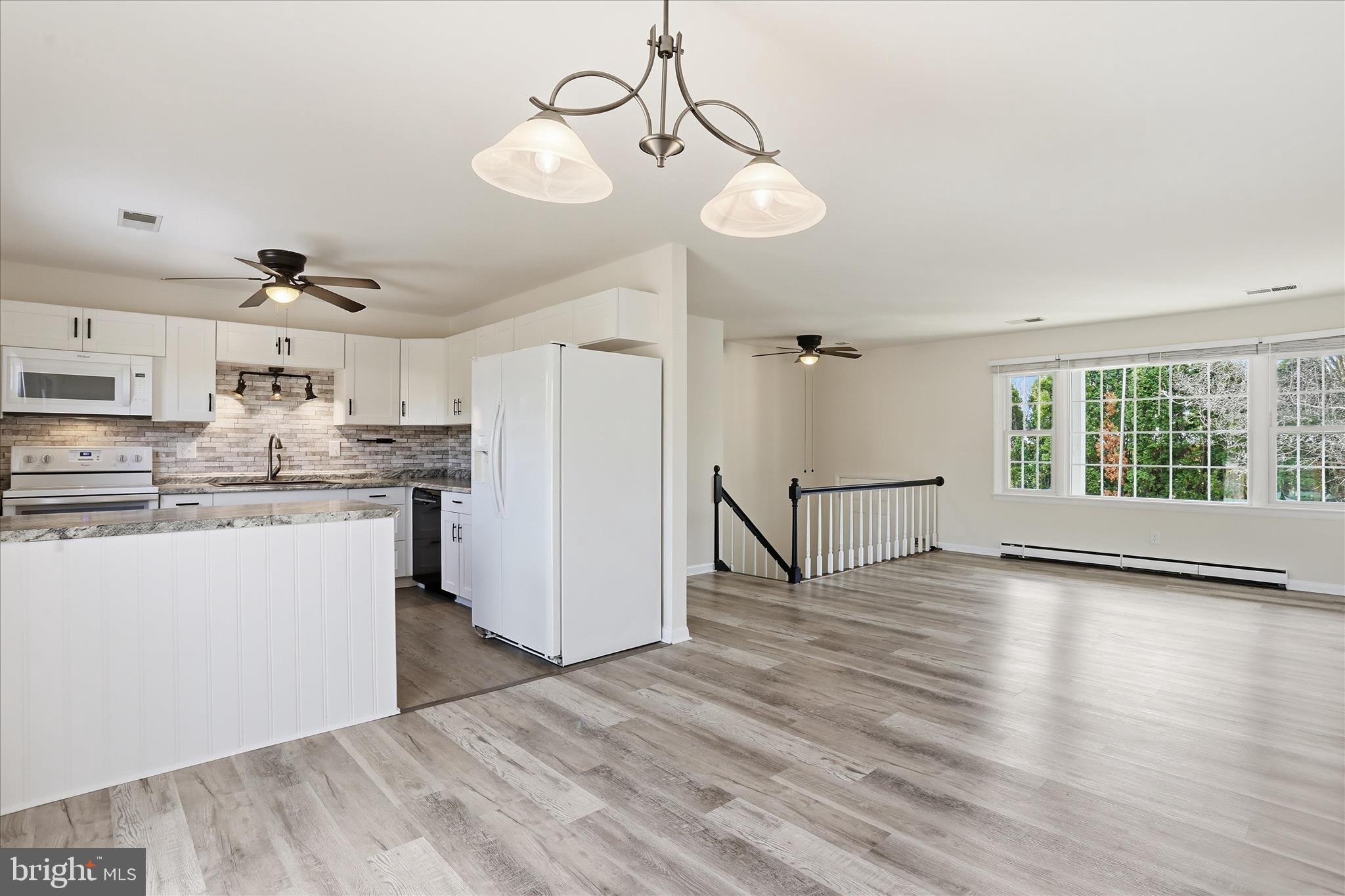 19022 Longmeadow Road Hagerstown, MD 21742 - Photo 4 of 30 a view of a kitchen with wooden floor and a refrigerator