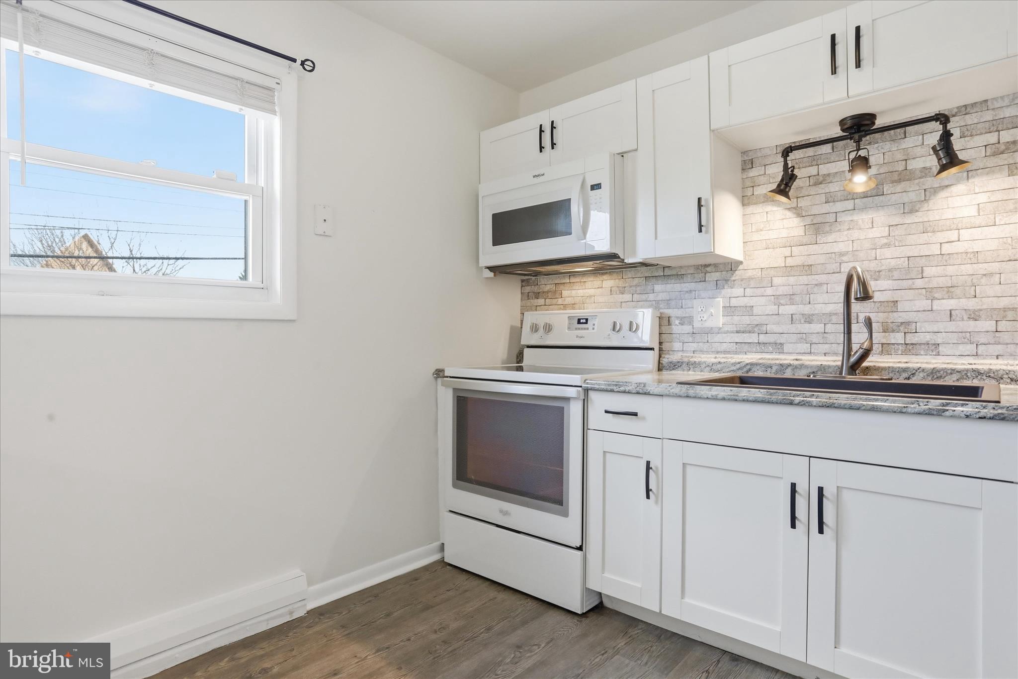 19022 Longmeadow Road Hagerstown, MD 21742 - Photo 6 of 30 a kitchen with stainless steel appliances granite countertop white cabinets and window