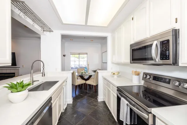 a kitchen with stainless steel appliances a refrigerator stove and microwave