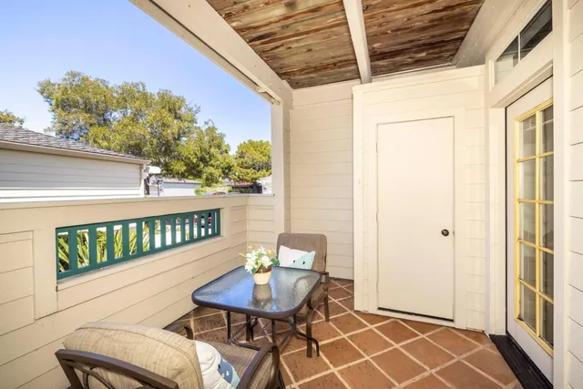 a view of a brick house with a large trees