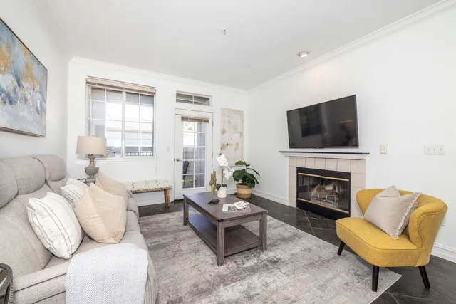 a living room with furniture a fireplace and a flat screen tv