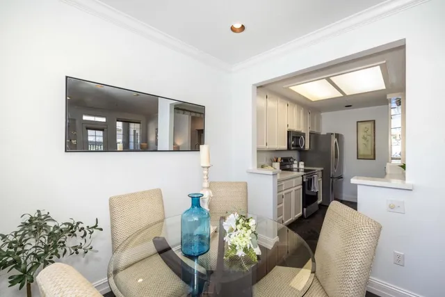 a living room with furniture and a kitchen