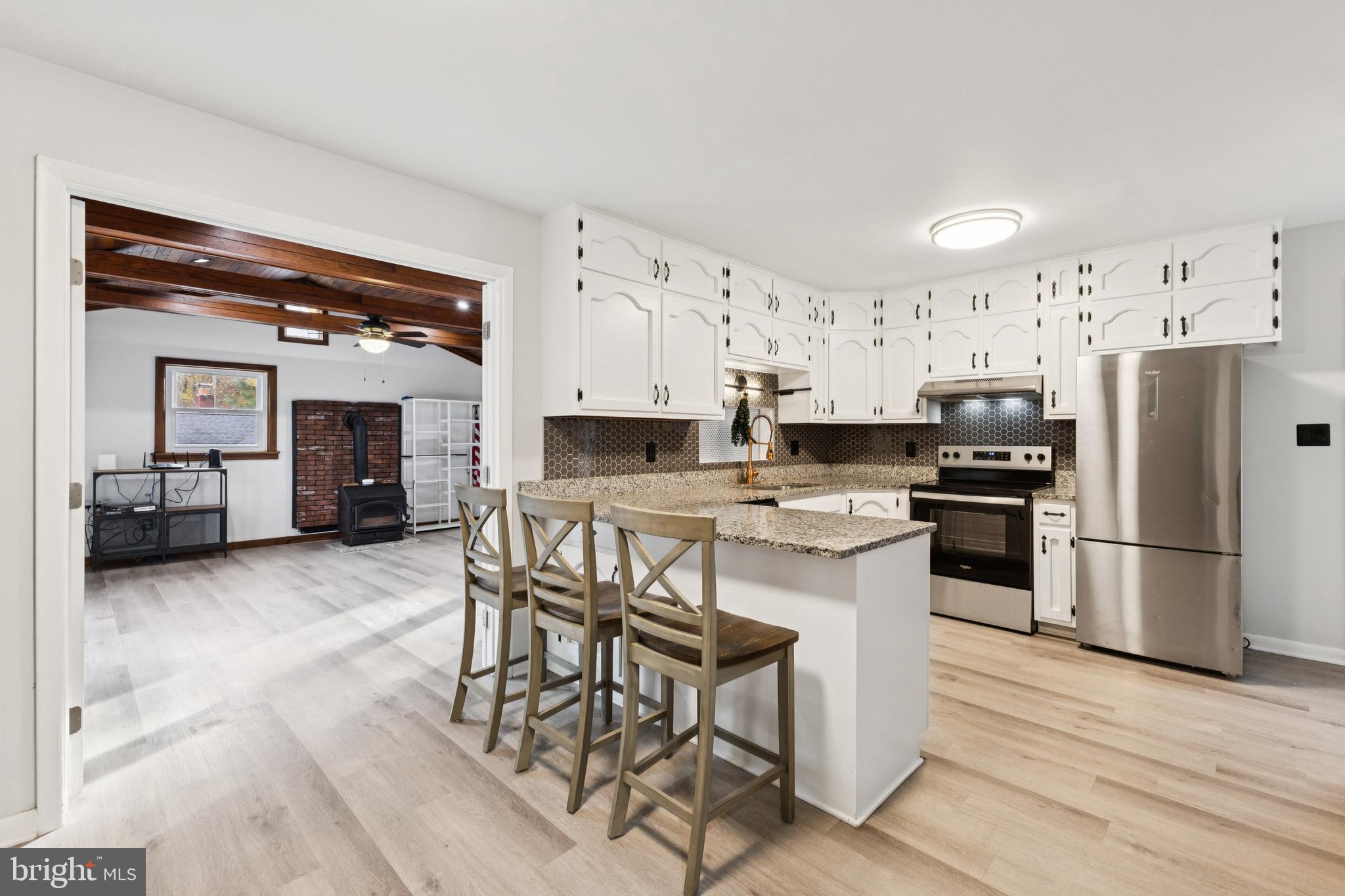 24530 Hollywood Road Hollywood, MD 20636 - Photo 11 of 40 a kitchen with stainless steel appliances a refrigerator stove microwave and cabinets