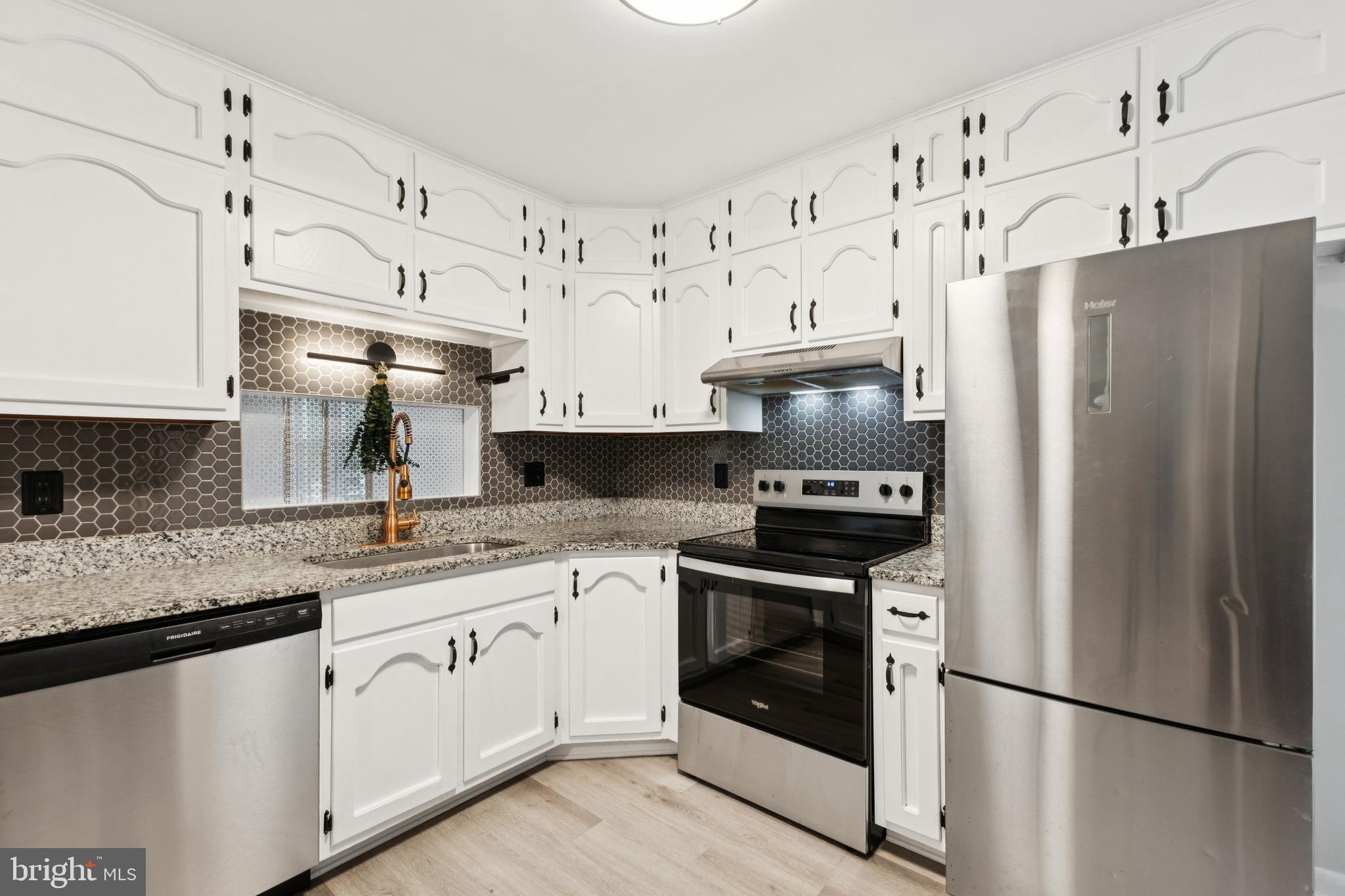 24530 Hollywood Road Hollywood, MD 20636 - Photo 12 of 40 a kitchen with stainless steel appliances granite countertop a refrigerator sink and white cabinets
