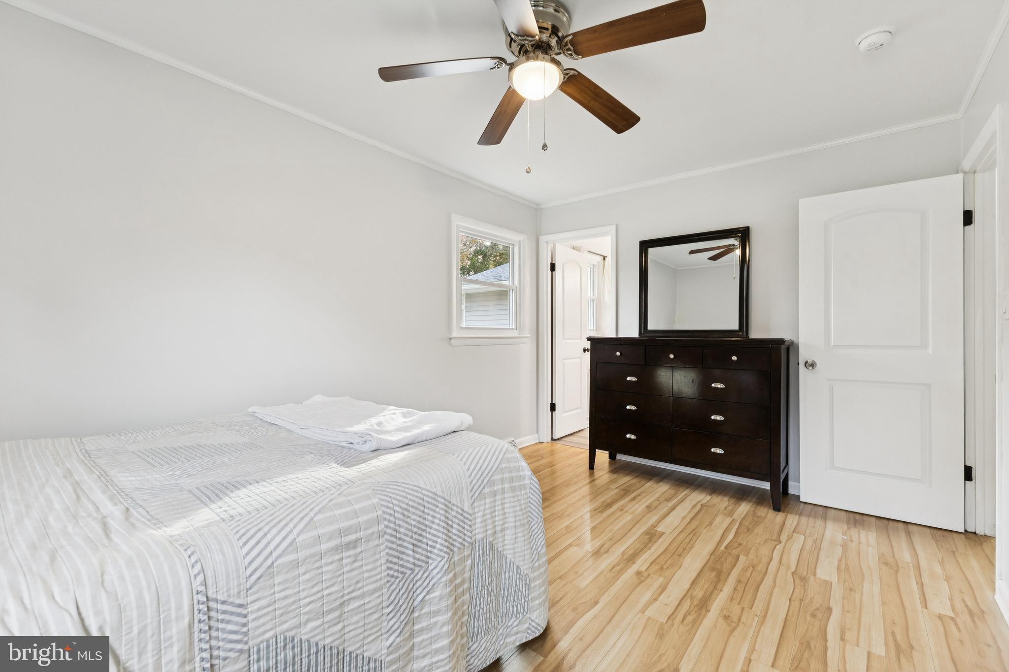 24530 Hollywood Road Hollywood, MD 20636 - Photo 21 of 40 a bedroom with a bed and a mirror on a dresser