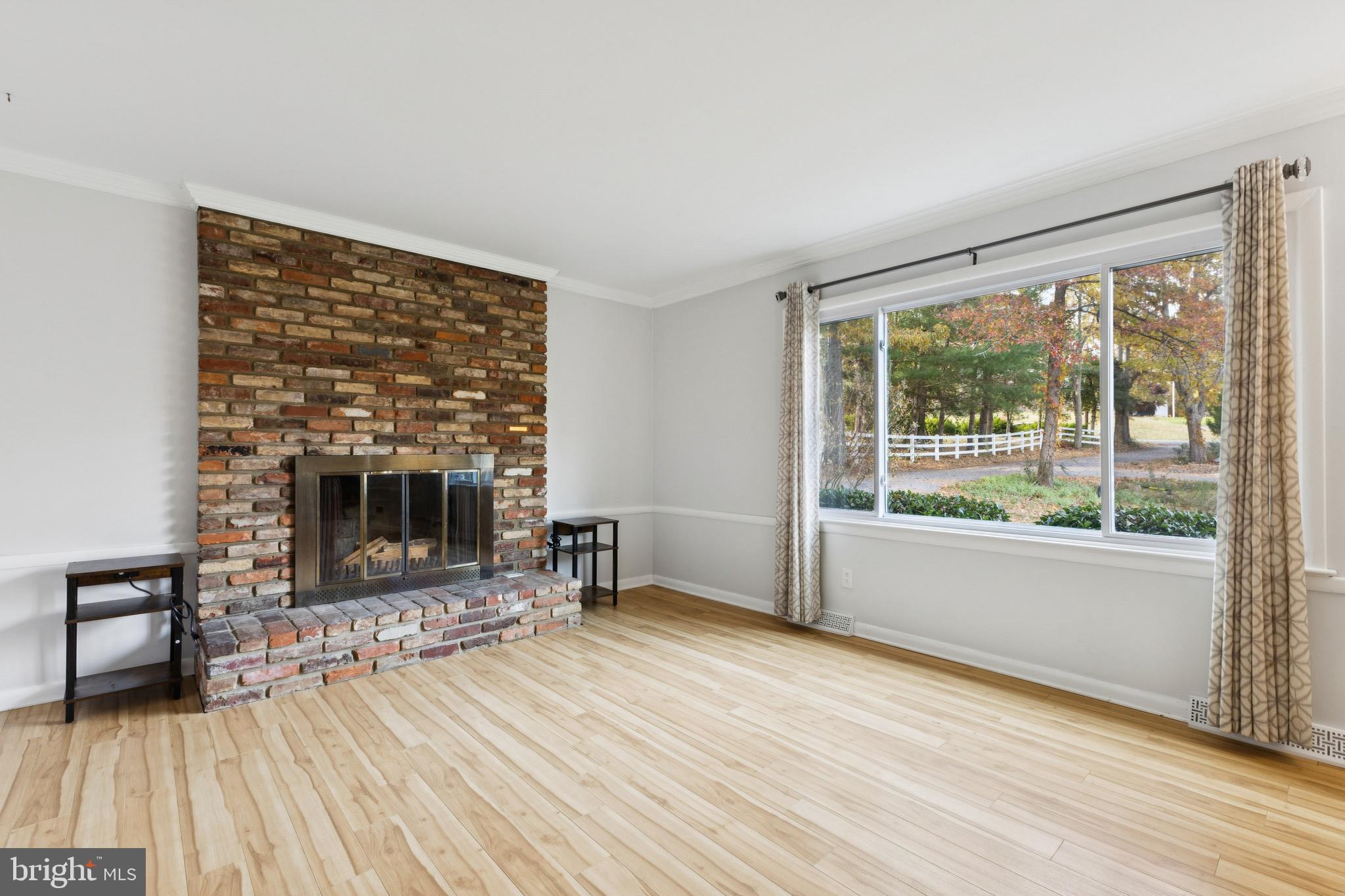 24530 Hollywood Road Hollywood, MD 20636 - Photo 9 of 40 a living room with furniture and a fireplace