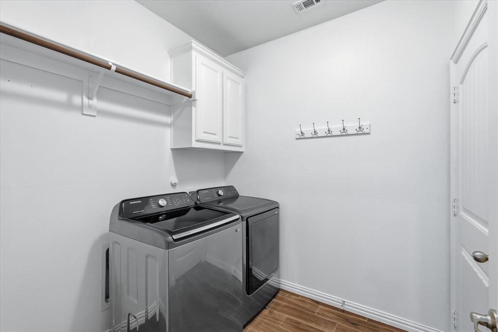 215 Equestrian Road Hickory Creek, TX 75065 - Photo 29 of 36 a kitchen with a sink and cabinets
