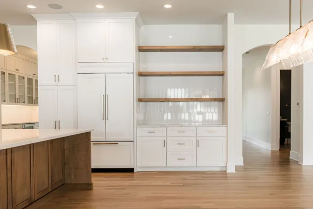 a close view of a sink a stove and microwave
