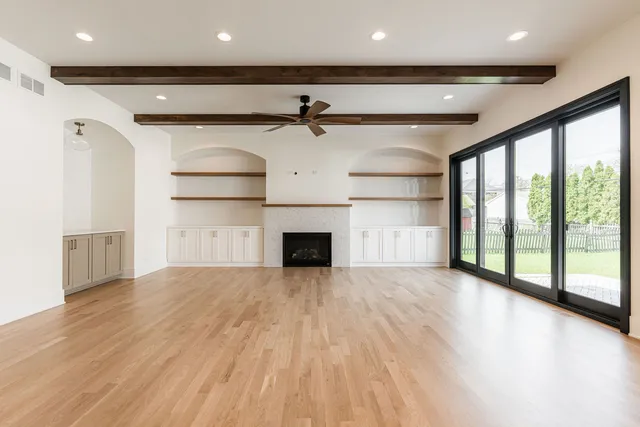 a kitchen with stainless steel appliances granite countertop a stove and wooden floor