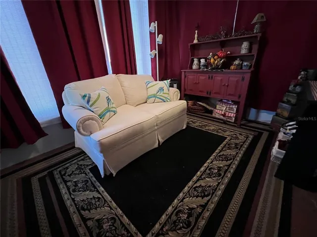 a view of a chairs and table in patio with a lake view