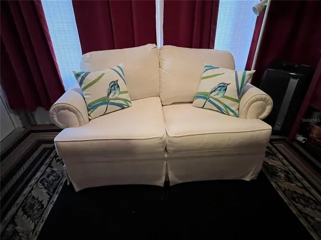 a view of a chairs and table in the balcony