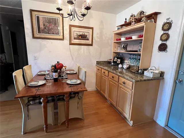 a kitchen with stainless steel appliances granite countertop a sink and wooden cabinets