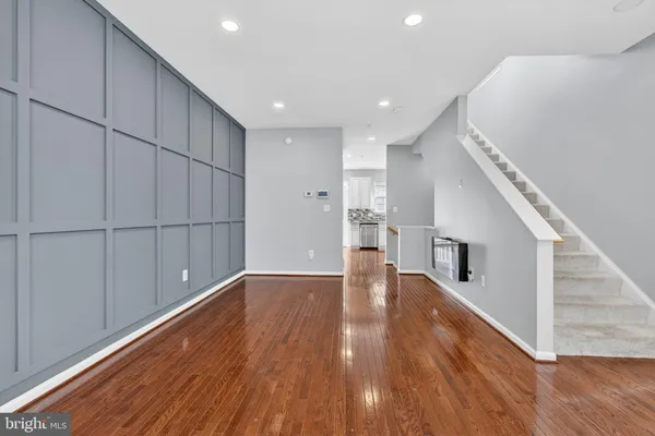 a view of empty room with wooden floor