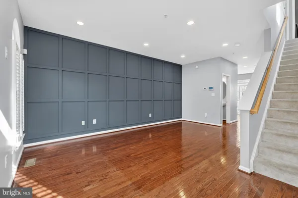 a view of empty room with wooden floor