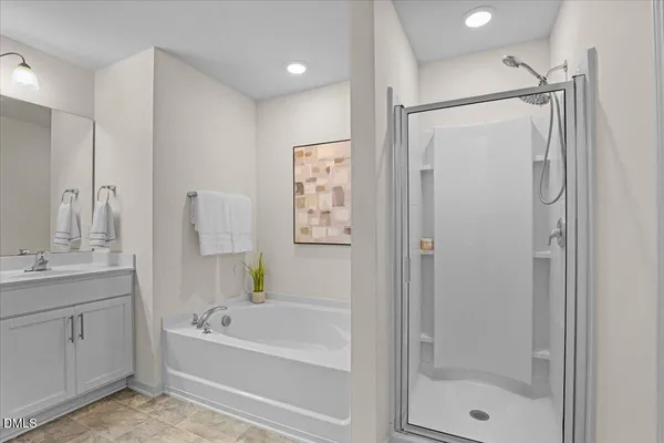 a bathroom with a tub a sink and a shower