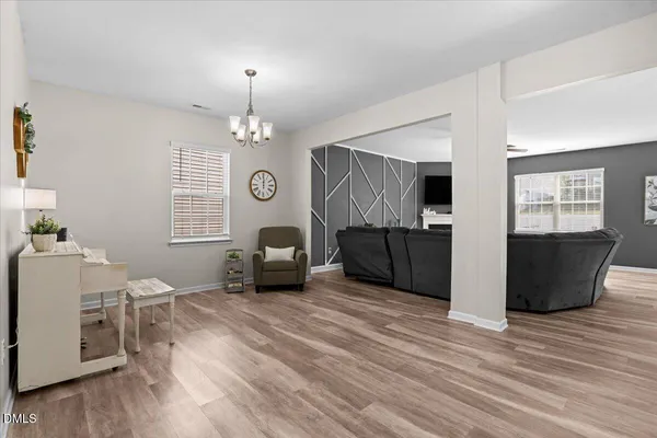 a view of a livingroom with furniture window and wooden floor