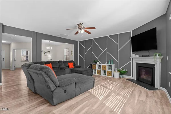 a living room with furniture a flat screen tv and a fireplace