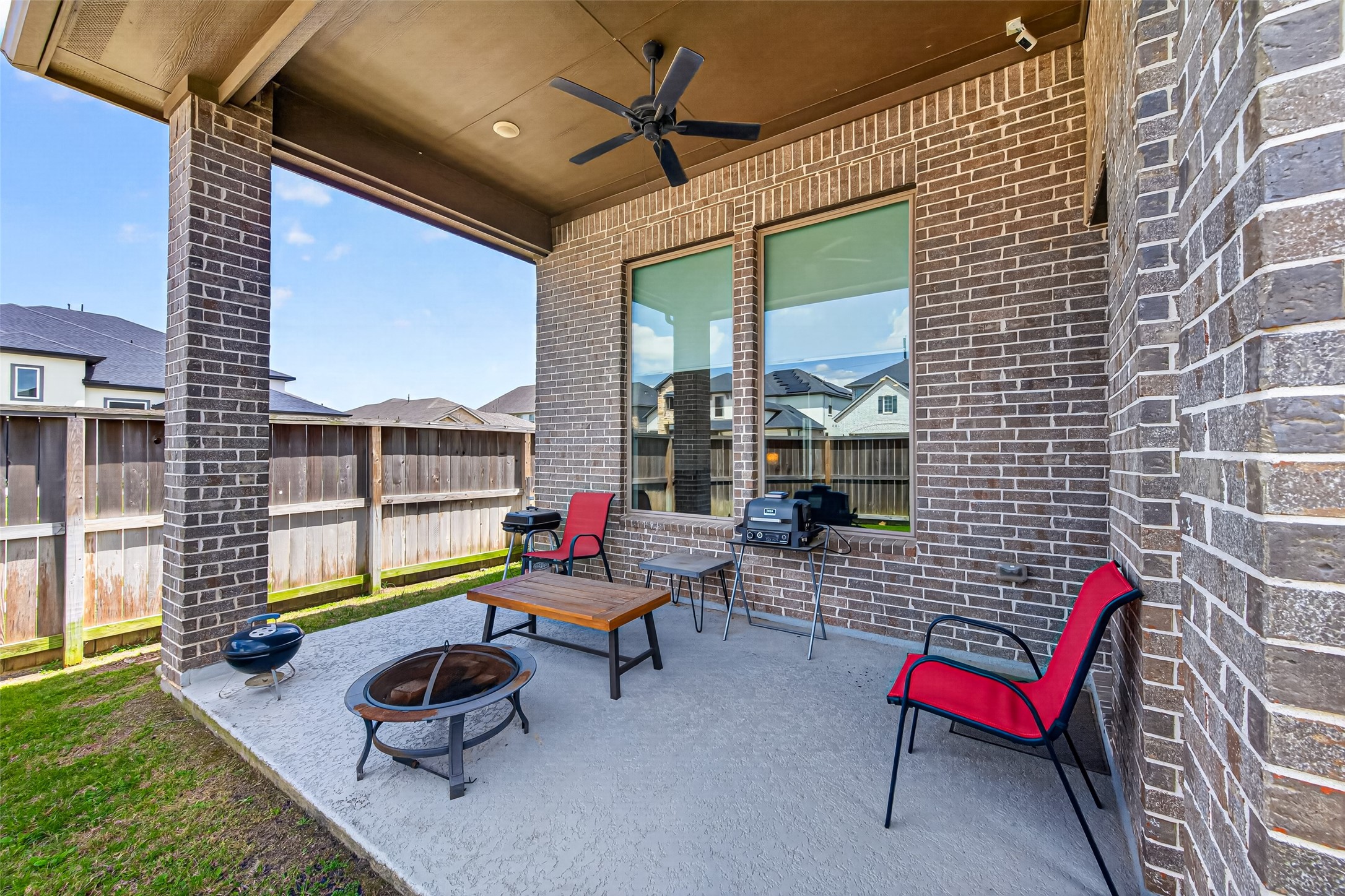 20802 Mirror Point Drive Cypress, TX 77433 - Photo 34 of 37 This area offers a tranquil setting, perfect for enjoying the outdoors in comfort and style. It's an inviting space for outdoor relaxation or entertaining, with a ceiling fan for comfort.