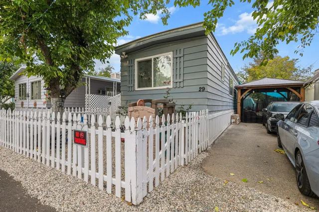 a front view of house with wooden fence
