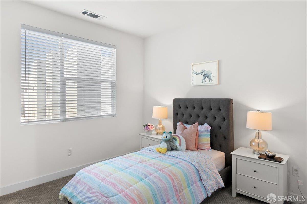 1807 16th Street Oakland, CA 94607 - Photo 15 of 45 a bedroom with a bed and a window