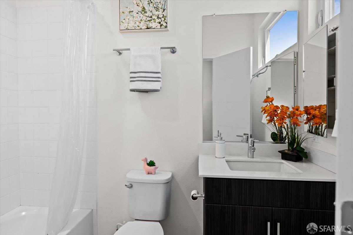 1807 16th Street Oakland, CA 94607 - Photo 18 of 45 a bathroom with a sink vanity mirror and toilet