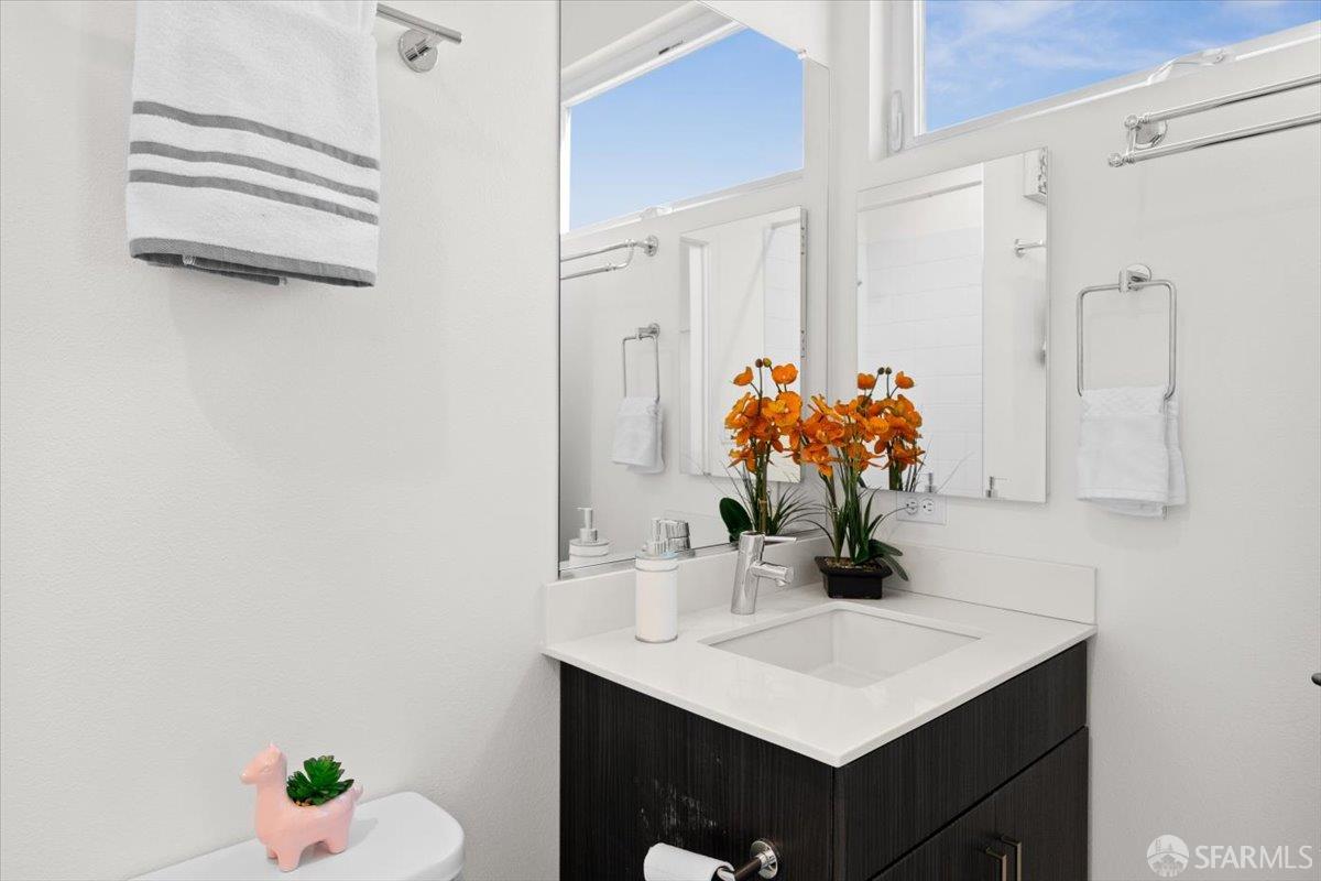1807 16th Street Oakland, CA 94607 - Photo 19 of 45 a bathroom with a sink vanity and a mirror