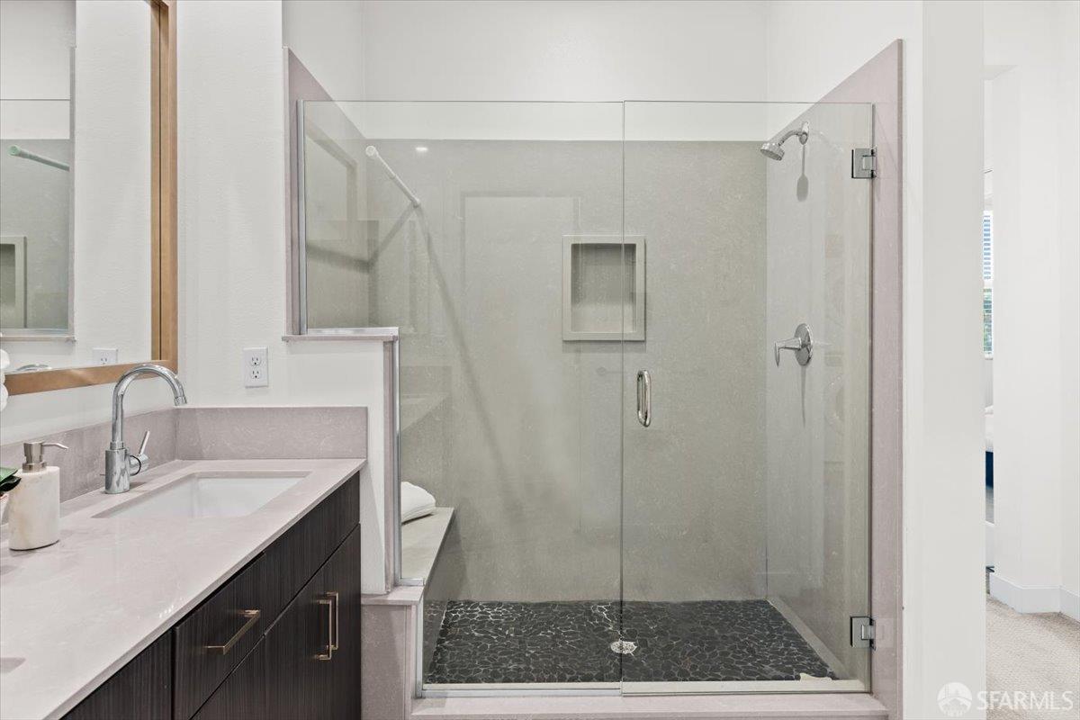 1807 16th Street Oakland, CA 94607 - Photo 22 of 45 a bathroom with a shower a sink and a mirror
