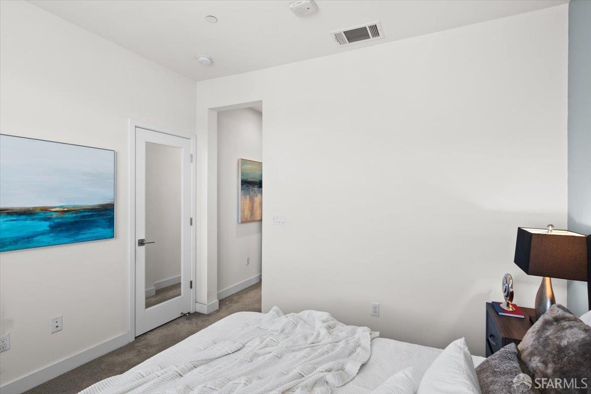 1807 16th Street Oakland, CA 94607 - Photo 26 of 45 a bedroom with a bed and a television