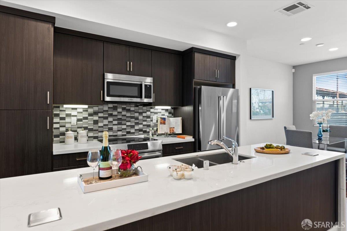 1807 16th Street Oakland, CA 94607 - Photo 7 of 45 a kitchen with a sink refrigerator and microwave