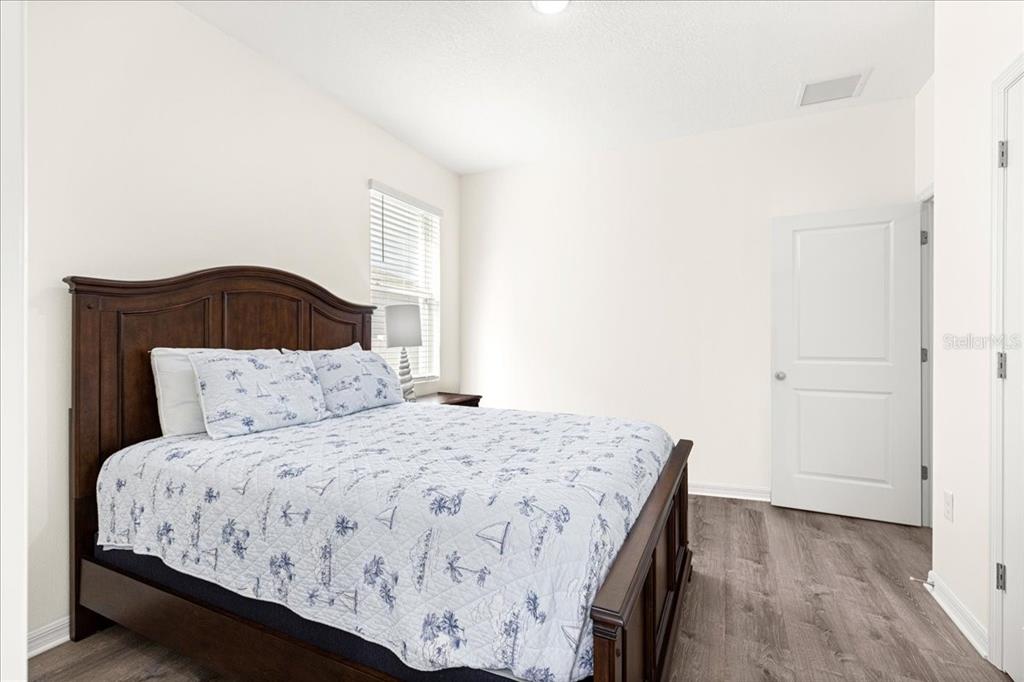 5851 Southwest 85th Place Ocala, FL 34476 - Photo 29 of 57 a bedroom with a bed and a painting on the wall