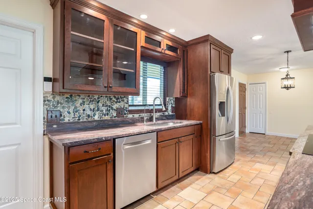 a view of kitchen with a sink and cabinet