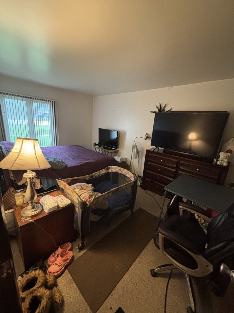 1050 Holbrook Road, Unit 1H Homewood, IL 60430 - Photo 10 of 10 a bedroom with a bed and a flat screen tv