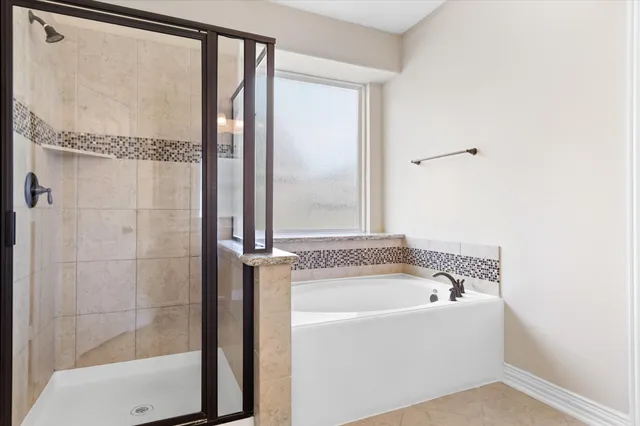 a bathroom with a bathtub and a shower