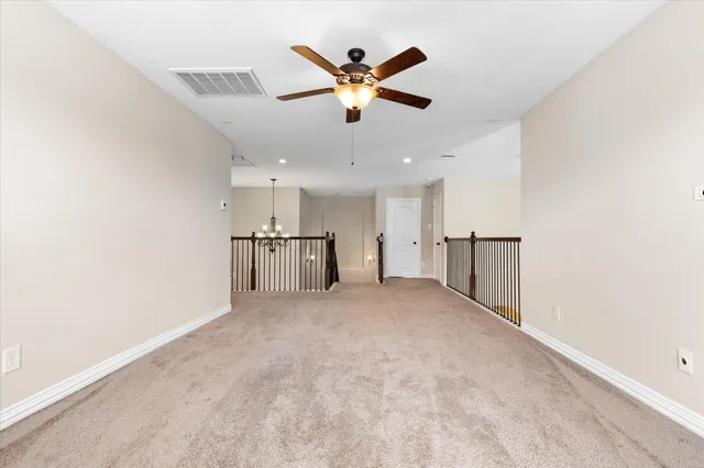 a view of an empty room with a ceiling fan