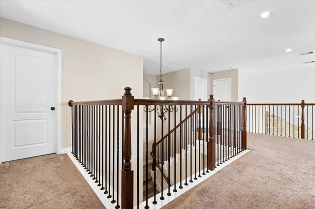 a view of a hallway with a window and stairs