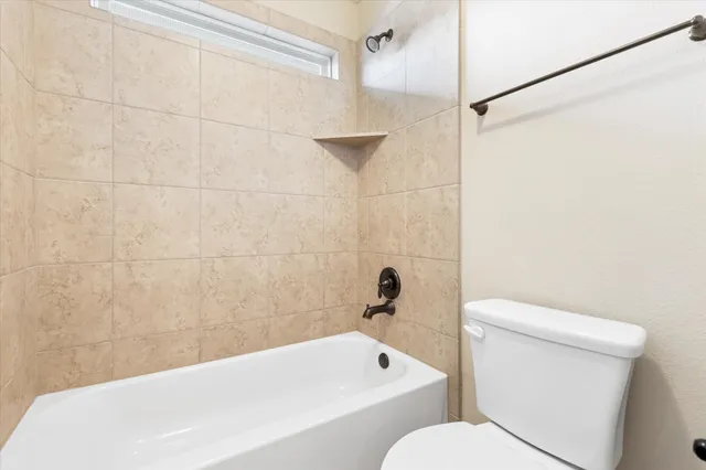 a bathroom with a toilet and a bathtub