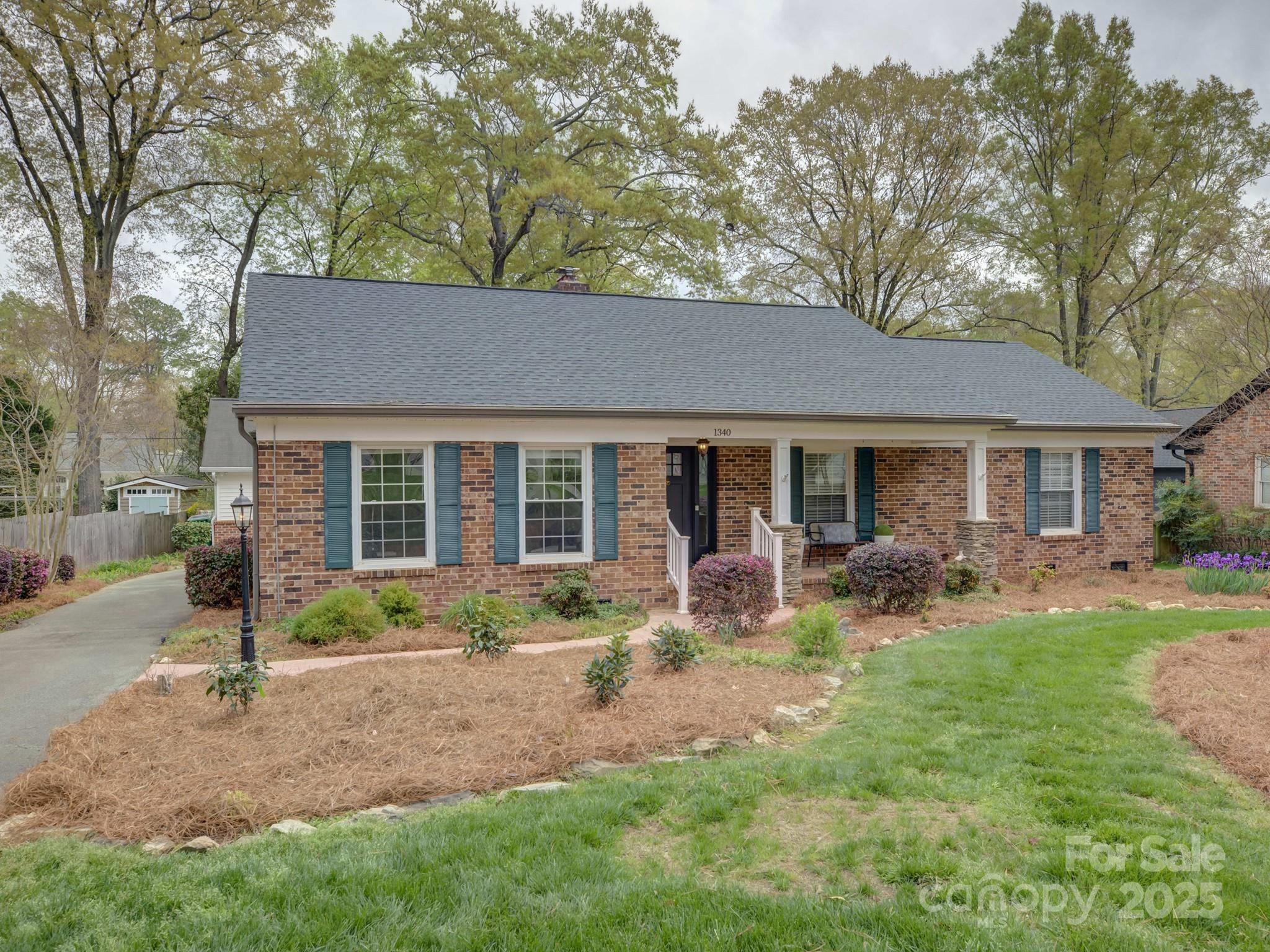 a front view of a house with yard patio and green space