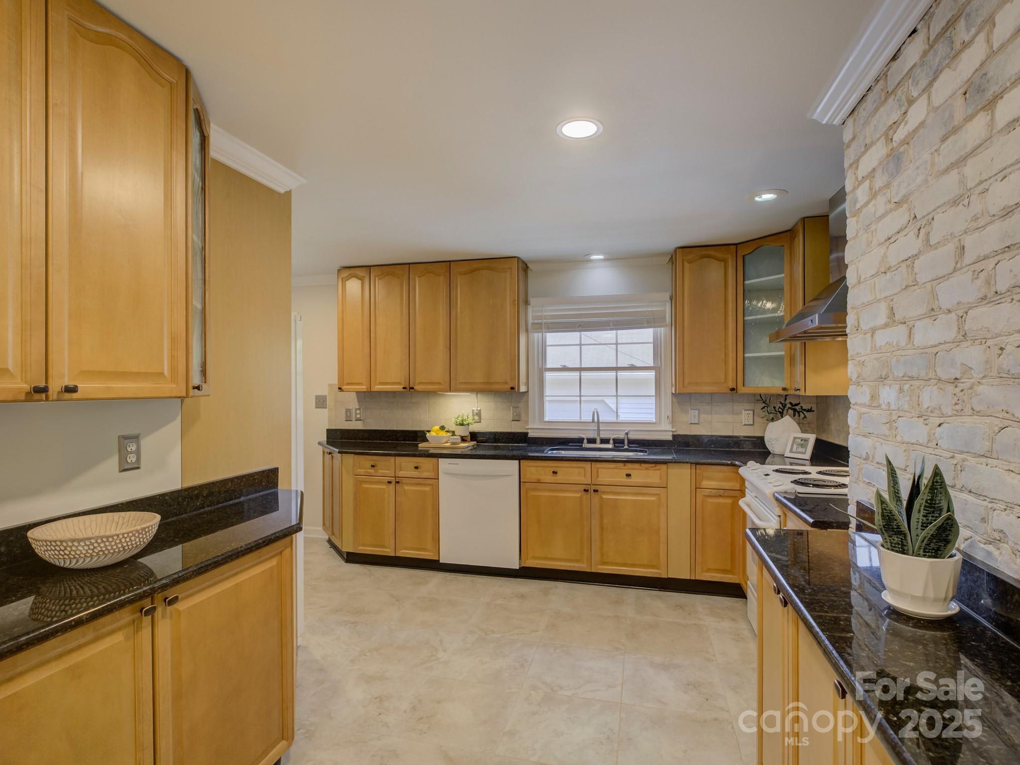 1340 Braeburn Road Charlotte, NC 28211 - Photo 12 of 46 a kitchen with stainless steel appliances granite countertop sink stove top oven and cabinets