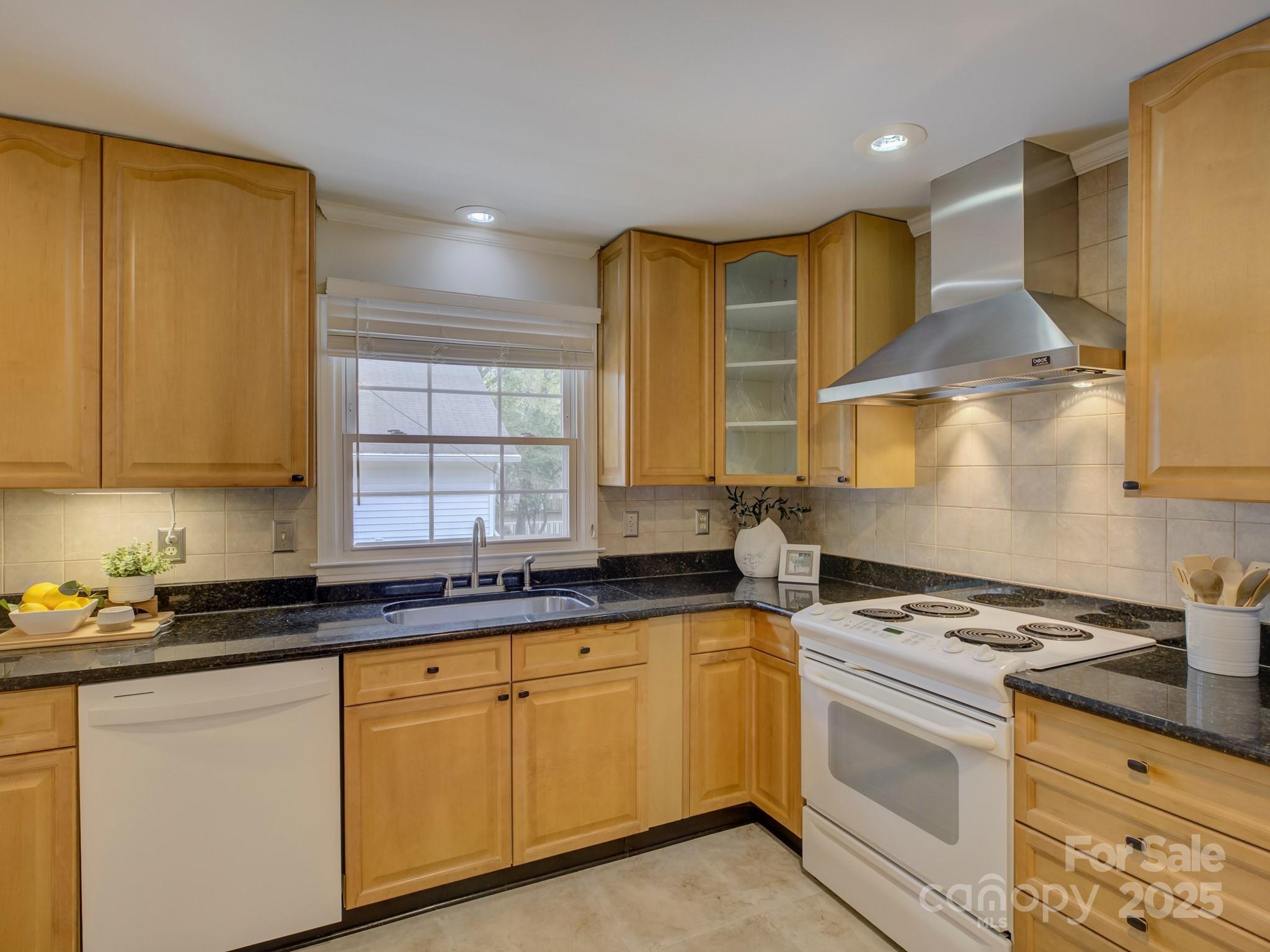 1340 Braeburn Road Charlotte, NC 28211 - Photo 13 of 46 a kitchen with granite countertop a sink a stove and cabinets