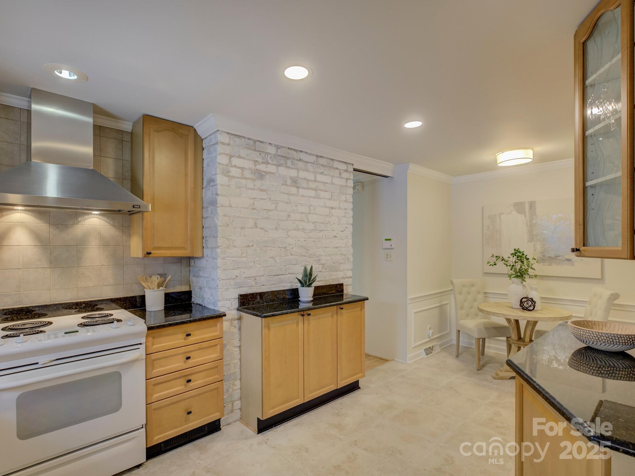 1340 Braeburn Road Charlotte, NC 28211 - Photo 16 of 46 a kitchen with stainless steel appliances kitchen island granite countertop a sink and cabinets