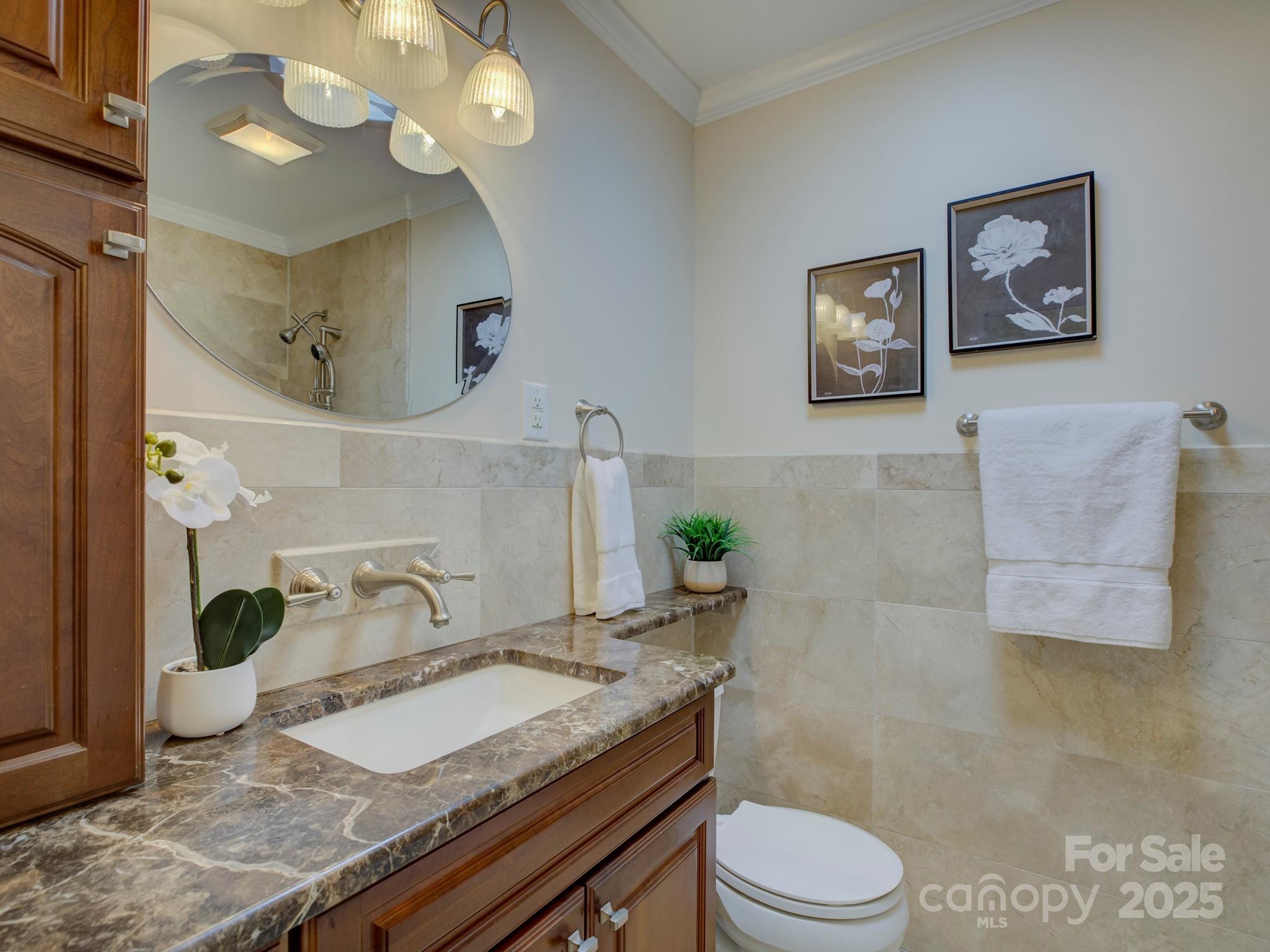 1340 Braeburn Road Charlotte, NC 28211 - Photo 25 of 46 a bathroom with a granite countertop toilet sink and mirror