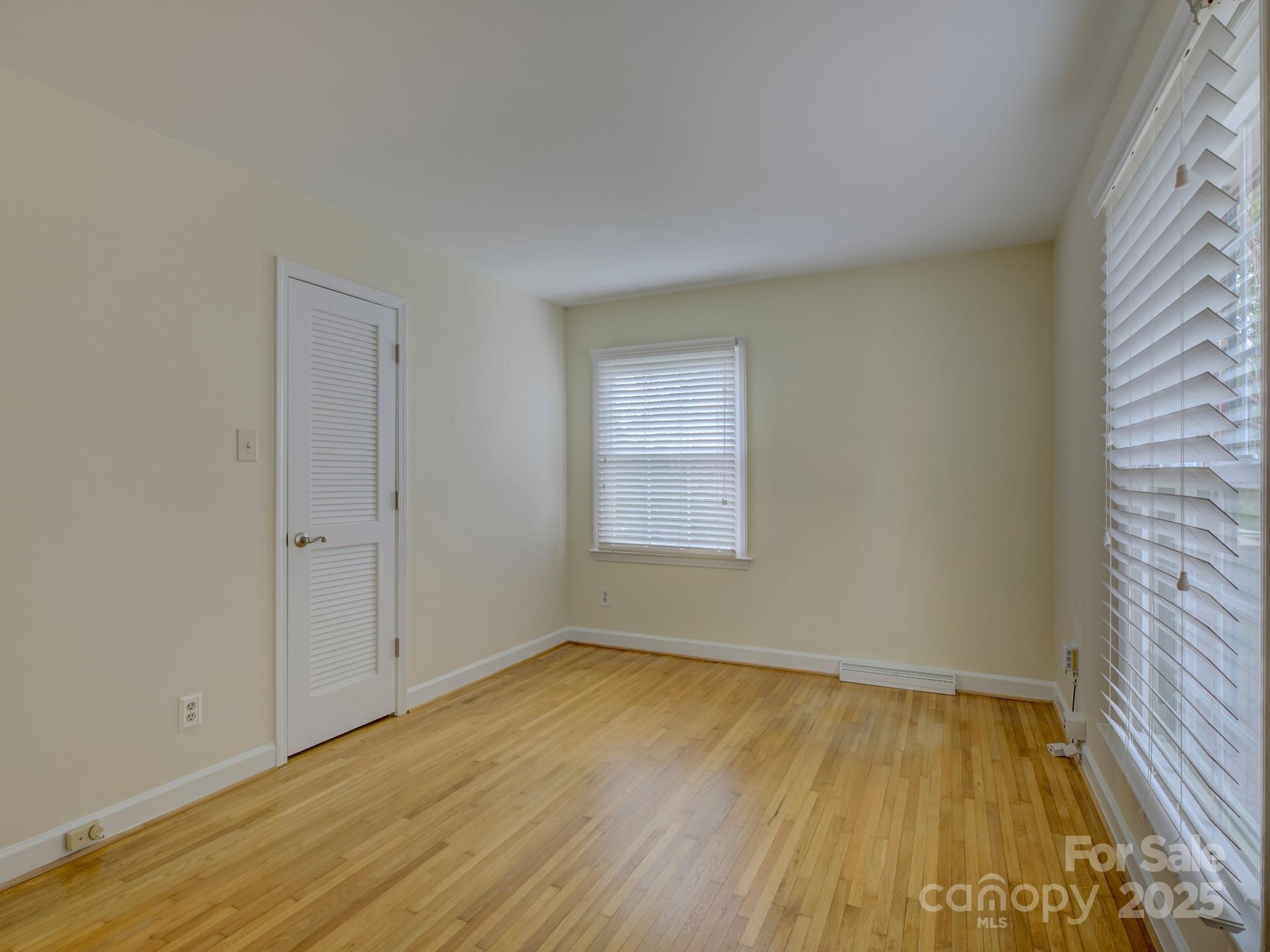 1340 Braeburn Road Charlotte, NC 28211 - Photo 28 of 46 a view of empty room with wooden floor and fan
