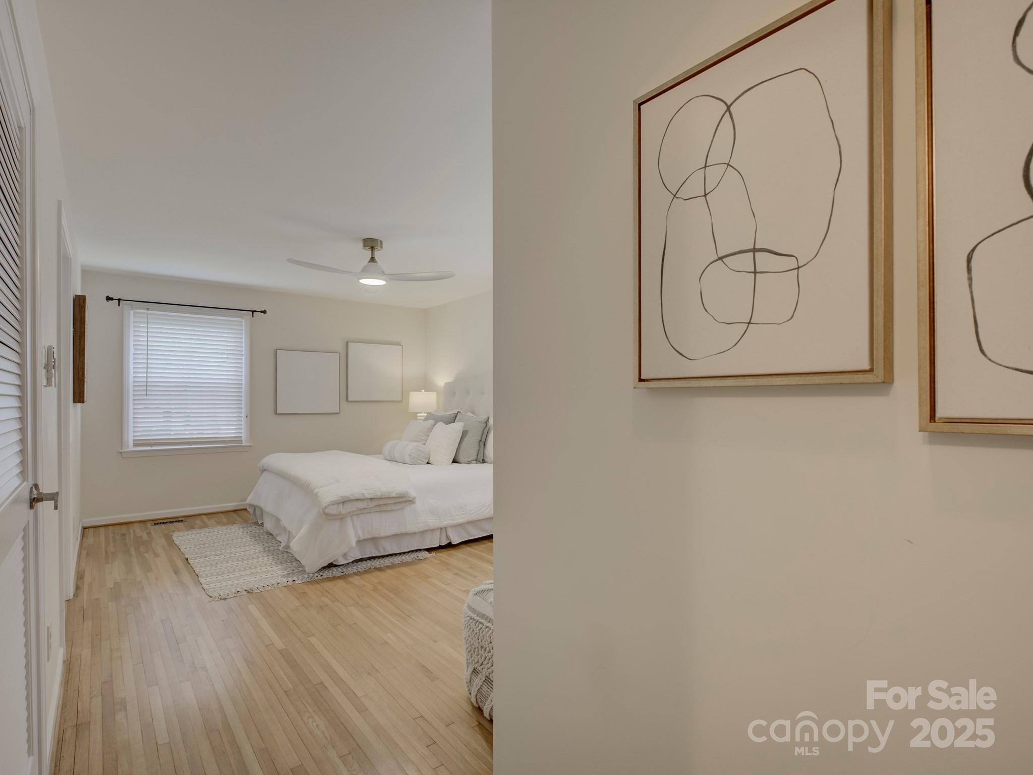 1340 Braeburn Road Charlotte, NC 28211 - Photo 29 of 46 a bedroom with a bed and a painting on the wall