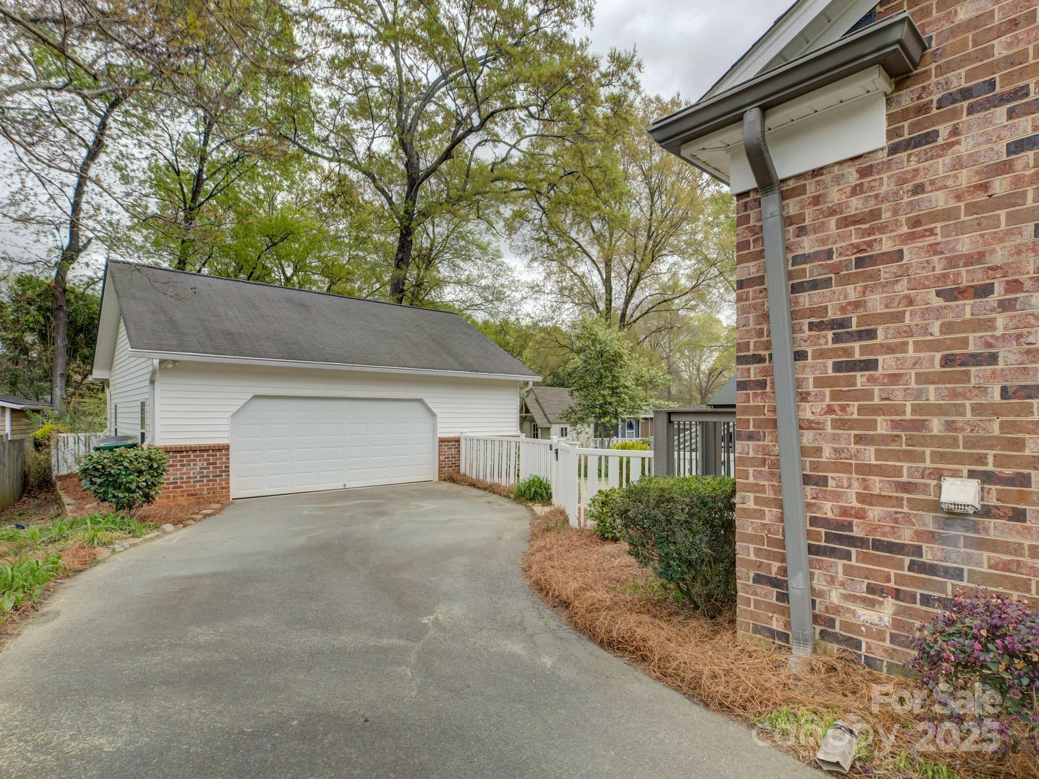1340 Braeburn Road Charlotte, NC 28211 - Photo 36 of 46 a front view of a house with a yard and garage