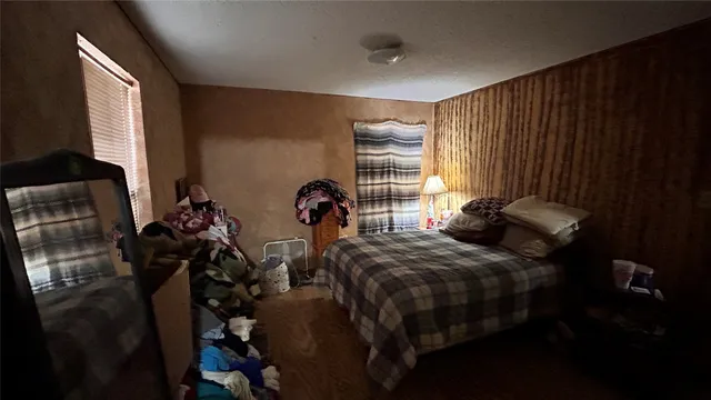 a bedroom with two beds and a window