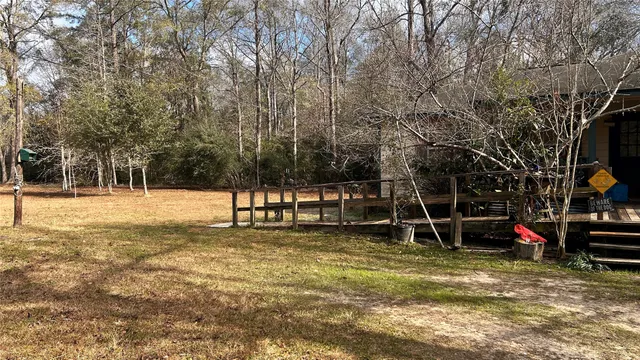 a backyard of a house with table and chairs